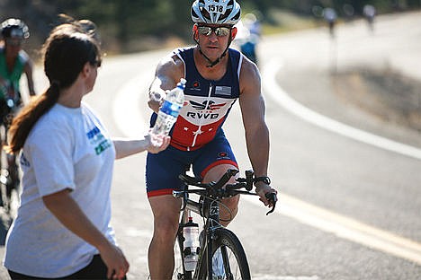 &lt;p&gt;Jason Loveland is handed a bottle of water by local Ironman volunteer Paige Riley.&lt;/p&gt;