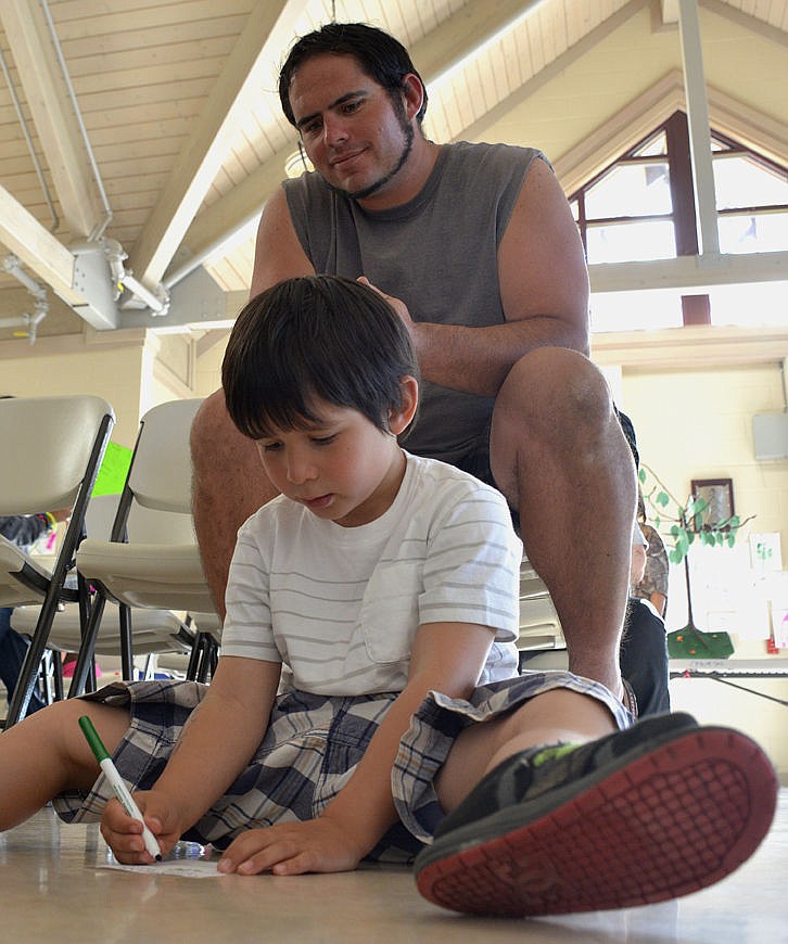 &lt;p&gt;&lt;strong&gt;Darrius Baltz, 5, works on his father&#146;s space ticket as dad, Roy Baltz watches. Three other Baltz children &#151; Dante, 9, Grace, 10, and Toni, 10, play nearby.&lt;/strong&gt;&lt;/p&gt;&lt;p&gt;&lt;strong&gt;&#160;&lt;/strong&gt;&lt;/p&gt;