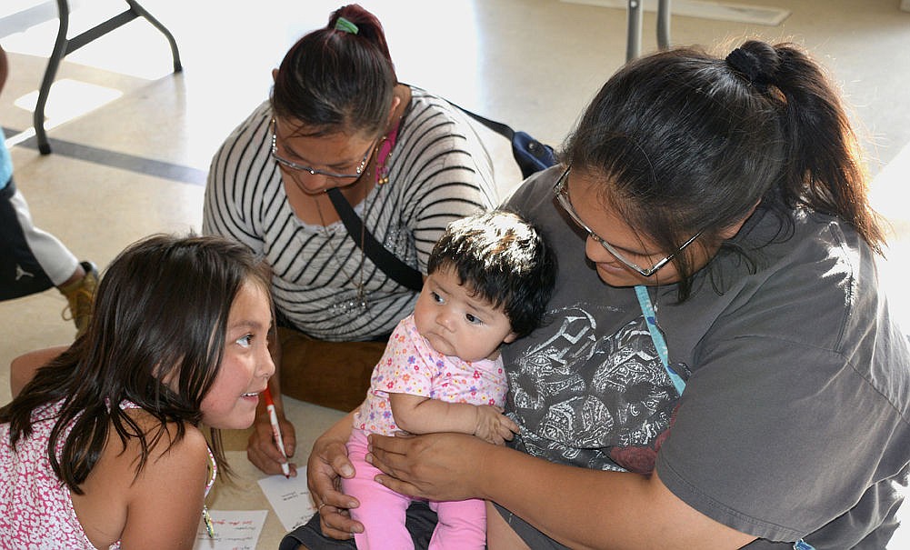 &lt;p&gt;Left to right, Adela Benn, 5, her mother Victoria Benn, Vanessa Baker and three-month-old Ruby Snapp work together to fill out their shuttle ticket information.&lt;/p&gt;