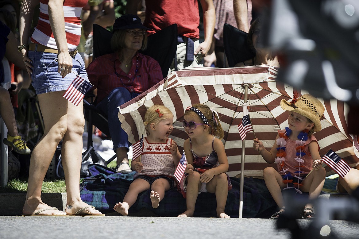 &lt;p&gt;From left, Aubrey Voorhees, Cate Storey, both 3, and Emmie Mail, 4, wave American flags Thursday during the Fourth of July parade along Sherman Avenue in Coeur d'Alene.&lt;/p&gt;