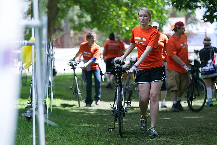 &lt;p&gt;JAKE PARRISH/Press&lt;/p&gt;&lt;p&gt;Ironman volunteer Kalli Batt of Coeur d'Alene wheels an Ironman participant's bike to its designated spot during the 2014 Ironman in Coeur d'Alene.&lt;/p&gt;