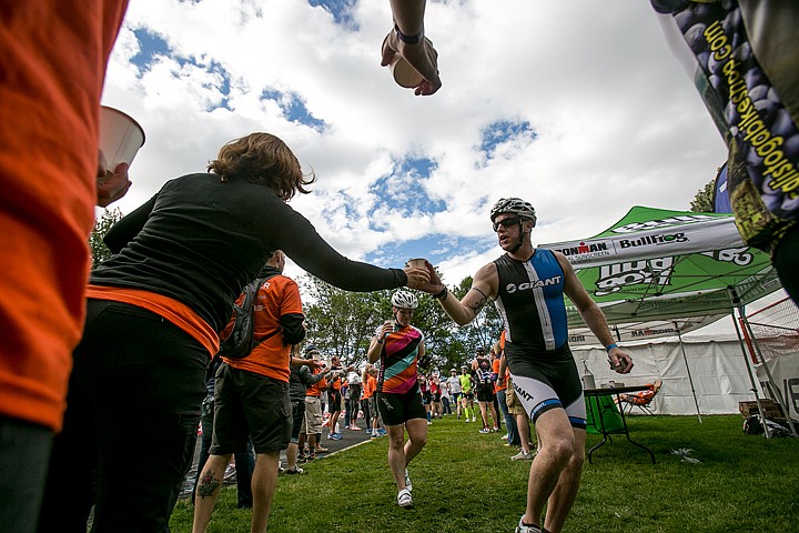 &lt;p&gt;JAKE PARRISH/Press&lt;/p&gt;&lt;p&gt;Volunteers pass out water cups to athletes in the swim to bike transition area in City Park during Ironman on Sunday.&lt;/p&gt;