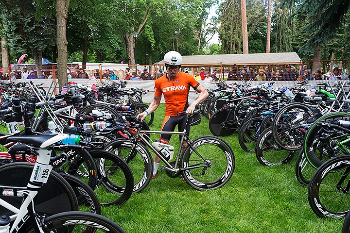 &lt;p&gt;SHAWN GUST/Press&lt;/p&gt;&lt;p&gt;Andrew Valki, of San Franciso, California, removes his bicycle from a rack in the first transition are of the Ironman race course.&lt;/p&gt;