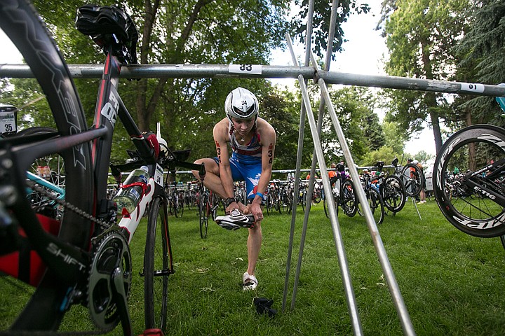 &lt;p&gt;JAKE PARRISH/Press&lt;/p&gt;&lt;p&gt;Professional triathlete Jennie Hansen slips her feet into her biking shoes before beginning the 112 mile bike segment of the Ironman triathlon on Sunday.&lt;/p&gt;