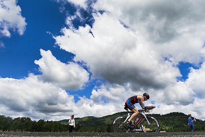 &lt;p&gt;SHAWN GUST/Press&lt;/p&gt;&lt;p&gt;A triathlete travels north along U.S. 95, passing an aid station near Fighting Creek Sunday during the 2014 Ironman Coeur d&#146;Alene.&lt;/p&gt;