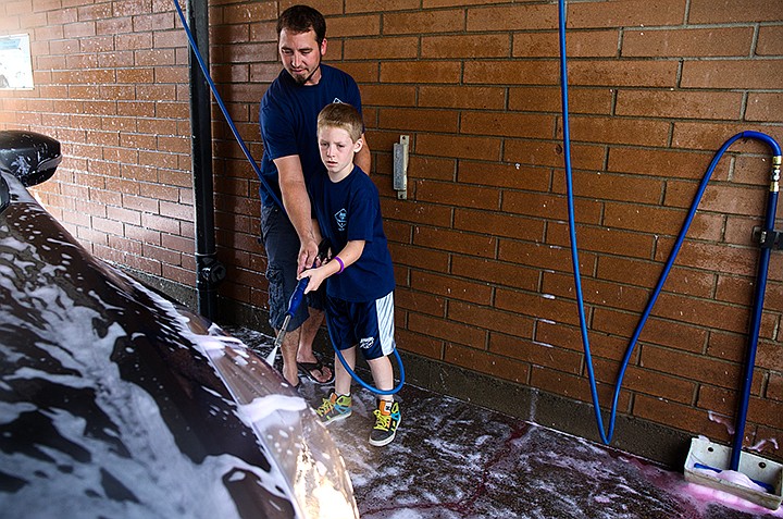 &lt;p&gt;TESS FREEMAN/Press&lt;/p&gt;&lt;p&gt;Shane Haney, 33 and his son Trevor Haney, 8, wash cars with their Cub Scout, pack 3, chartered through Ramsey Elementary&#160;School to raise money for the Haney Foundation to benefit their wife and mother, Kaylynn Haney, who has been fighting lung cancer since 2011. After two rounds of chemotherapy and one round of radiation the Haney&#146;s are trying an alternative treatment that isn&#146;t covered by their insurance and costs $50,000. The family has been able to raise $42,000 through fundraisers, donations from friends, their church and an online fundraiser at www.giveforward.com.&lt;/p&gt;