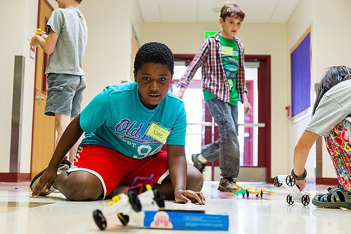 &lt;p&gt;SHAWN GUST/Press&lt;/p&gt;&lt;p&gt;Nate Bullock, 9, watches his car drive over the end of a small ramp while students of Camp Invention test out their vehicles Thursday during the week-long science camp at Ramsey Magnet School in Coeur d'Alene. The camp, that ends today with a showcase for parents at 2:40 p.m., taught first through sixth grade students skills based on Science Technology Engineering and Technology curriculum.&lt;/p&gt;