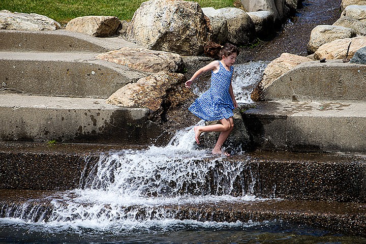 &lt;p&gt;TESS FREEMAN/Press&lt;/p&gt;&lt;p&gt;Ava Belisle, 7, of Spokane&#160;cools off in the water feature at Independence Point on Saturday afternoon.&lt;/p&gt;