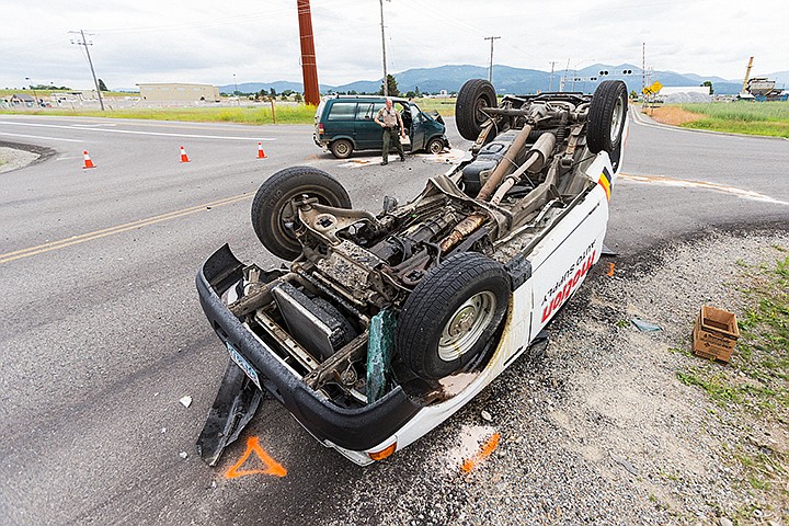 &lt;p&gt;SHAWN GUST/Press&lt;/p&gt;&lt;p&gt;Kootenai County Sheriff&#146;s Office deputy Josh Leyk investigates the scene of a two vehicle crash that ended with a pick up rolling onto its top Tuesday at the intersection of Pleasant View Road and Prairie Avenue in Post Falls. Drivers of both vehicles, both female, were transported to Kootenai Health with non-life threatening injuries.&lt;/p&gt;