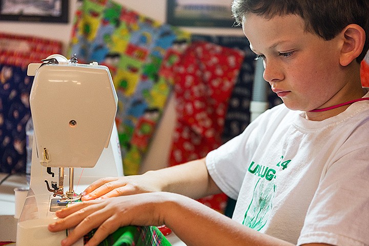 &lt;p&gt;SHAWN GUST/Press&lt;/p&gt;&lt;p&gt;Henry Wilcox, 8, uses a sewing machine to make panel for a pillow during a camp hosted by the North Idaho Quilters guild Tursday at the Coeur d&#146;Alene Shrine Club event center in Hayden. More than 30 area children attended the three-day camp, learning basic sewing skills. Children made a variety of items such as tissue holders, pillows, pillow covers tote bags and quilts. The pillow covers will be donated to Konker Cancer and will be used at the Shriner&#146;s Children&#146;s Hospital.&lt;/p&gt;