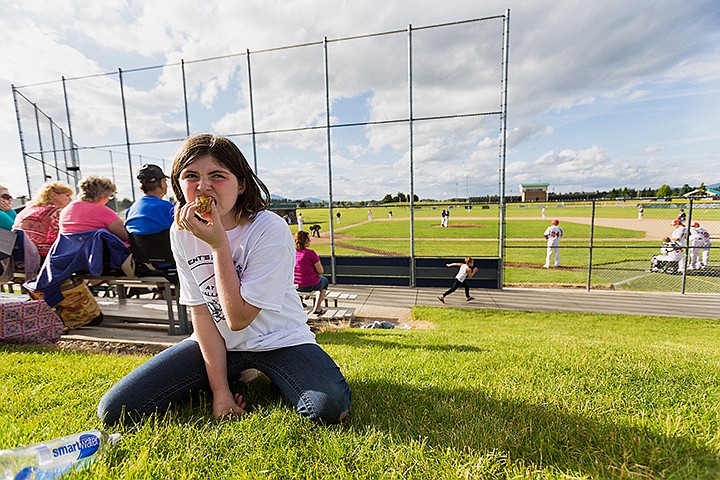 &lt;p&gt;SHAWN GUST/Press&lt;/p&gt;&lt;p&gt;Zo&euml; McConnell, 9, enjoys a hot dog and a baseball game Tuesday during Parents Premier Night at the Ballpark, a CDA 4 Kids event, at Lake City High School. Donations from Premier Sports Center, University of Idaho, Sports Cellar Underground Expressions and the Coeur d&#146;Alene School District helped to put on the event.&lt;/p&gt;