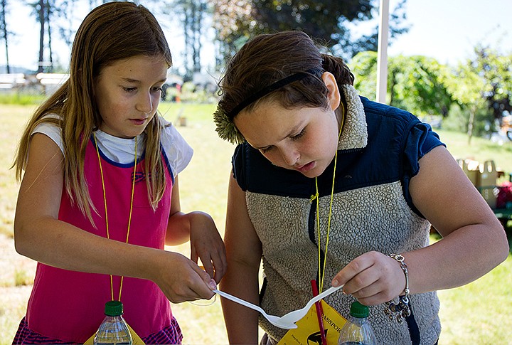 &lt;p&gt;TESS FREEMAN/Press&lt;/p&gt;&lt;p&gt;Jelena Pomeroy, 10, gives Kaia Poorboy, 10, a caddisfly to examine at the University of Idaho&#146;s event for fourth graders from Hayden Meadows Elementary School to learn about water quality and ecosystems.&lt;/p&gt;