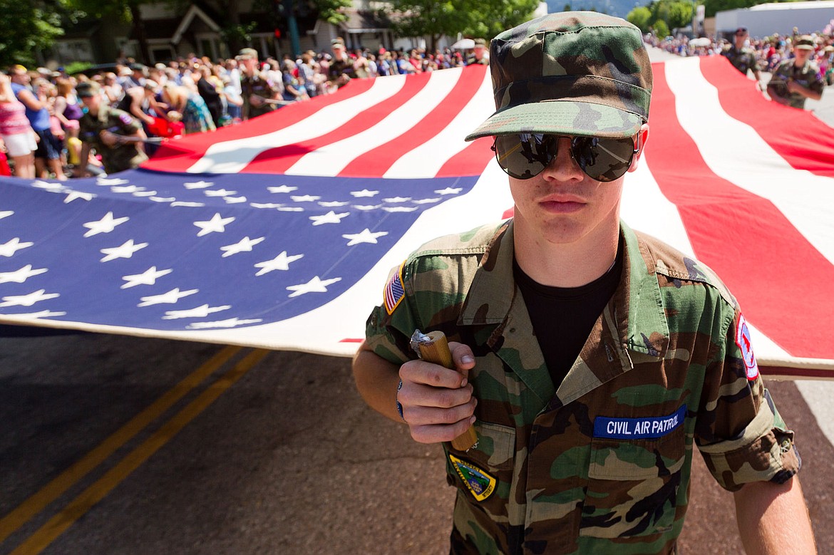 &lt;p&gt;Jake Bussey, an airman with the United States Air Force Civil Air Patrol, leads other cadets in displaying a massive American flag during the Fourth of July parade.&lt;/p&gt;