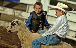 Wyatt Schulz of Arlee hangs on during the mutton-busting event of the Mission Mountain PRCA Rodeo last weekend in Polson.