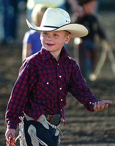 Jackson Seifert, of Polson, takes the walk from the arena entrance to the chutes looking all the part of a championship mutton-buster during the Mission Mountain PRCA Rodeo last weekend in Polson.