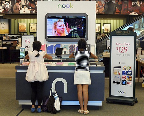 &lt;p&gt;Customers look at models of the Nook tablet at a Barnes and Noble store in Pineville, N.C., on June 21.&lt;/p&gt;