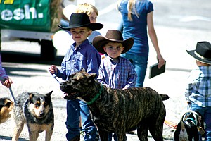 Gavin Knutson, 6, gets ready for the pet parade with his pup Lilly while 3-year-old Ryle Lytle tends to his Walker Hound Hobey.