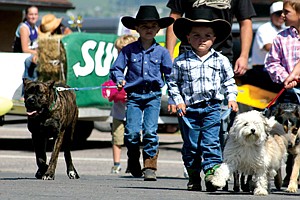 Gavin Knutson, 6, walks his Italian mastiff Lilly, while his brother, 4-year-old Ryley marches with his pug Shasta during Friday's pet parade.