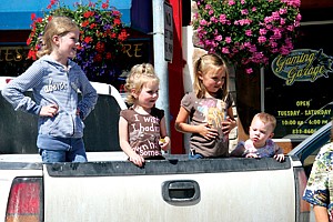 The Gilmore girls: Kayleigh, 7, Aubrey, 3, and Adeline, 1, watch from the bed of a truck with their friend Maria Nelson, 5, as the parade files by on Main Street.