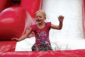 Arianna Zempel, 6, gets a cool surprise on a hot day at the 16th Annual St. Ignatius Firemen&#146;s Picnic last Saturday. People of all ages enjoyed games, auctions and delicious barbeque at the event.