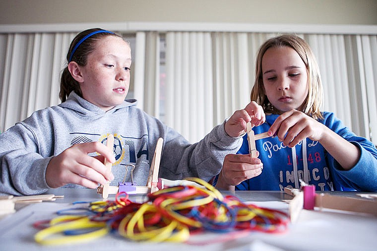 &lt;p&gt;Seventh-grader Emma Paulson, left, helps third-grader Kennedy Moore with her mini catapult Thursday afternoon during Kid's College at Flathead Valley Community College in Kalispell. Students created a variety of miniature contraptions in the Creative Catapults and Soda Straw Rockets class, one of several classes offered during second week of the summer session. Kid's College provides students hands-on experiences with a variety of subjects such as art, science and sports. June 26, 2014 in Kalispell, Montana. (Patrick Cote/Daily Inter Lake)&lt;/p&gt;