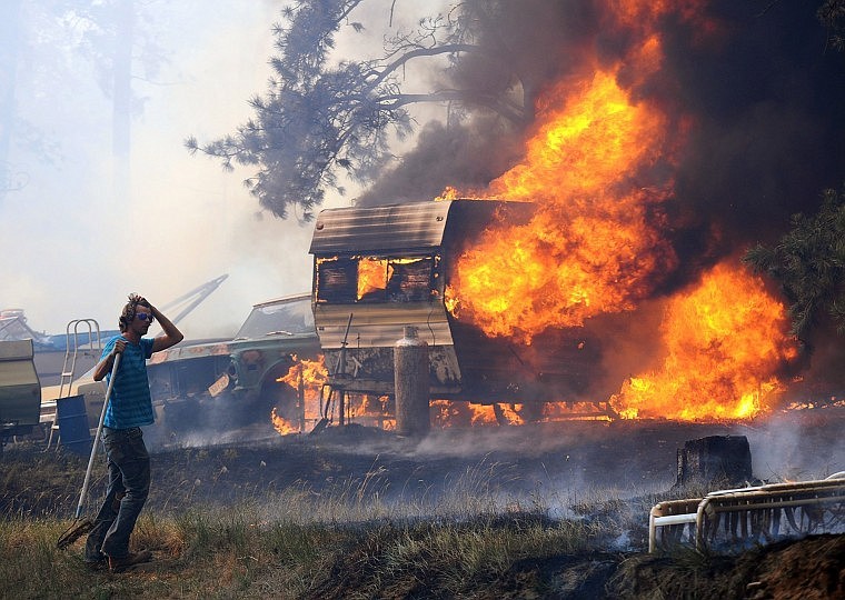 &lt;p&gt;Volunteers and firefighters from the Dean Creek Fire Department work to save a home south of Roundup Tuesday. Hundreds of families were forced from their homes south of Roundup as a fire pushed by strong winds burned more than 18,000 acres and destroyed 60 homes.&lt;/p&gt;