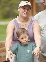 <p>Michelle Mead of Missoula and her son Aiden, 7, listen to instructions during a group activity at the For One Another Family Camp in Kalispell, June 22. The camp is held each year for families who have been diagnosed with cancer.</p>