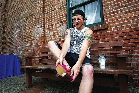 &lt;p&gt;Owen Benson, 20, attempts to squeeze his foot into a high heel shoe Saturday to participate in &quot;Walk a Mile in Her Shoes&quot; fundraiser to stop violence toward women.&lt;/p&gt;