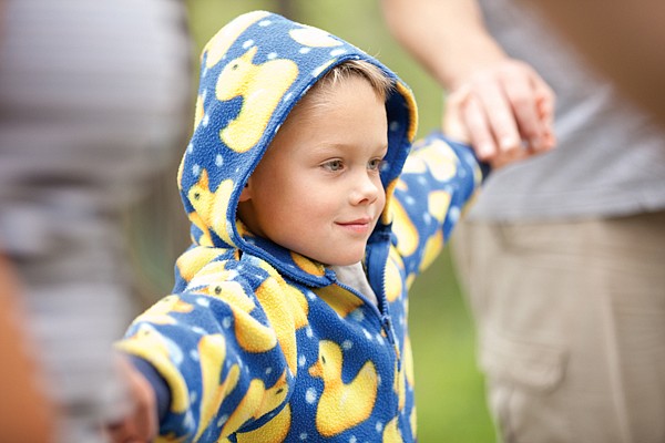 <p>Six-year-old Mitchell Schauers from Bozeman holds hands with other campers while the group tries to balance on wooden platform during a challenge called whale watching. The camp offers a fun-filled agenda for all ages.</p>