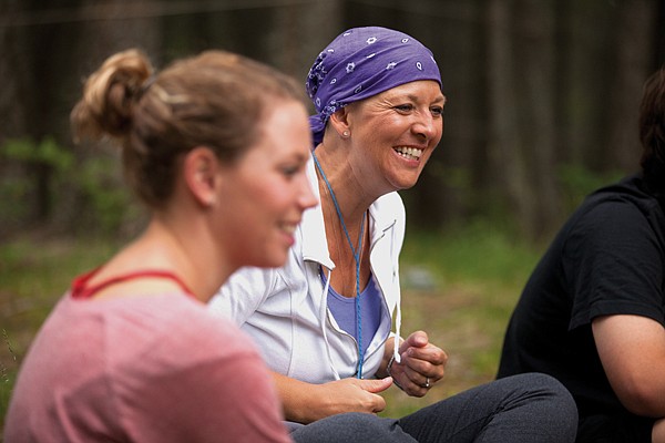<p>Melinda Bachini from Billings, right, and her daughter Samantha Kiefer enjoy a group session at the For One Another Family Camp in Kalispell, June 22. The camp is free for Montana families affected by a cancer diagnosis by the Cancer Support Community of Montana.</p>