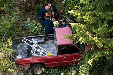 <p>JAKE PARRISH/Press Steve Elmore is pulled by emergency crews from his pickup truck that slid more than 50 feet down an embankment in Bayview on Monday. Elmore suffered non-life threatening, but serious injuries to his legs.</p>