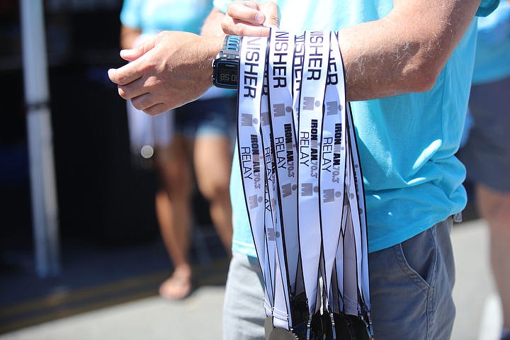 &lt;p&gt;KATIE HARTWIG/Press Volunteers wait at the finish line to hand out medals to all Ironman triathlete finishers, Sunday.&lt;/p&gt;