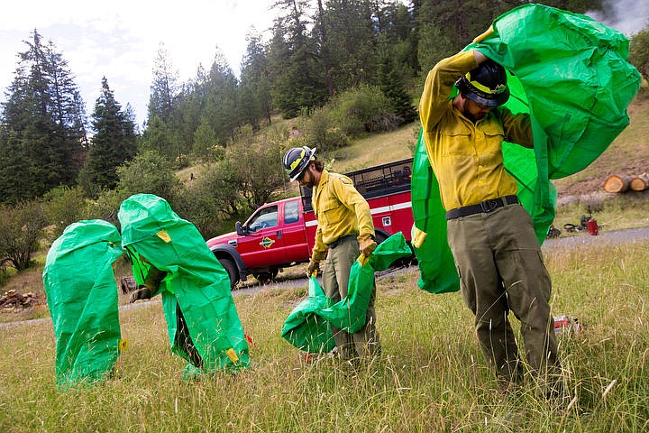 &lt;p&gt;JAKE PARRISH/Press Firefighters from the Idaho Department of Lands deploy emergency fire shelters during a demonstration on Thursday at the Funk Family Tree Farm in Wolf Lodge.&lt;/p&gt;