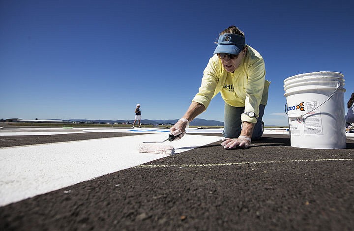 &lt;p&gt;LOREN BENOIT/Press Intermountain chapter of the Northwest section of the 99s member Elsbeth Roach &quot;Earmarks&quot; the new Coeur d'Alene Airport Compass Rose with white pain on Saturday, June 3, 2016. The 99s used 50 gallons of paint for 80 feet in diameter Compass Rose.&lt;/p&gt;