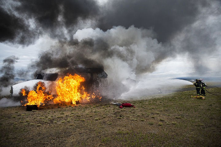 &lt;p&gt;LOREN BENOIT/Press Northern Lakes firefighters Caleb Tyler and Capt. Scott Hochberger spray the front-half of a plane during a two-plane crash exercise at the Coeur d'Alene Airport on Friday, June 10, 2016.&lt;/p&gt;