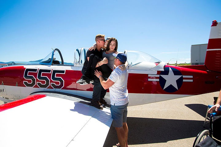 &lt;p&gt;JAKE PARRISH/Press Jamie Babin, 30, is lifted into the cockpit of Jerry Goggin's 1958 T-34 Beechcraft airplane on Friday at Pappy Boyington Airfield.&lt;/p&gt;