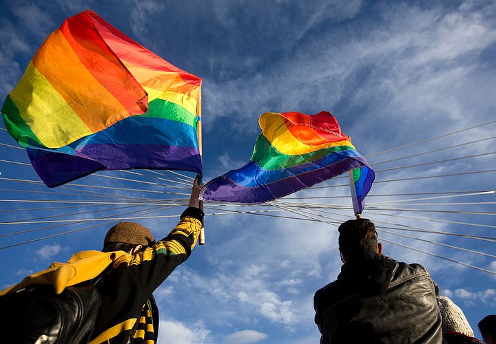 &lt;p&gt;JAKE PARRISH/Press Jessica Brereton, left, and Acen Lopez, both of Coeur d'Alene, wave gay pride flags at a vigil held for the victims of the Orlando shooting.&lt;/p&gt;