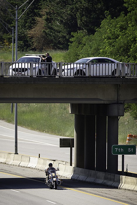 &lt;p&gt;Eric Johnson, an officer with the Coeur d'Alene Police Department, aims his automatic weapon on home where a suspect in an aggravated assault was believed to be barricaded.&lt;/p&gt;