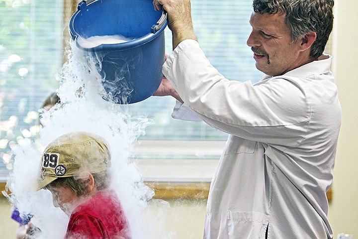 &lt;p&gt;JEROME A. POLLOS/Press Radical Rick Turner pours carbon dioxide fog over the top of Hunter Magistrale, 7, during an &quot;extreme science&quot; demonstration Wednesday at the Post Falls Library. Turner presented various science experiments highlight the affects of air pressure and chemical reactions during the interactive hour-long show.&lt;/p&gt;