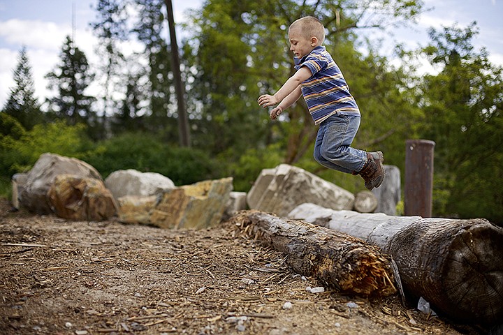 &lt;p&gt;JEROME A. POLLOS/Press Conner Hepler, 4, jumps from a log along the shoreline of the Spokane River near the former Atlas Mill site in Coeur d'Alene during a rambunctious outing Monday with his uncle.&lt;/p&gt;