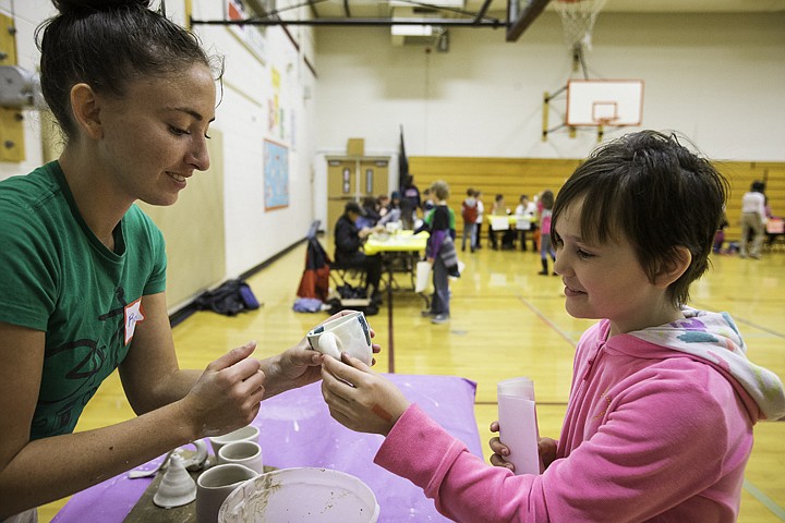 &lt;p&gt;SHAWN GUST/Press Alyssa Neuman, a fourth grade student at Fernan Elementary School, appreciates the artistry in Robyn Lieggi's pottery Tuesday during an event at the Coeur d'Alene school where local artists share their talents with the students.&lt;/p&gt;