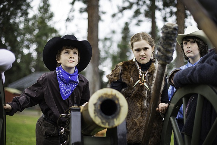 &lt;p&gt;SHAWN GUST/Press Dressed in western garb, Kameron Fisher, far left, Julia Moore, and Aaron Rowley listen to a presentation about civil war cannons Thursday at Ponderosa Elementary during the Post Falls school's annual Rendezvous Day where fourth graders learn about life in 19th century America.&lt;/p&gt;