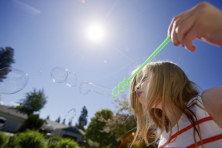 &lt;p&gt;JEROME A. POLLOS/Press Cambriah Anderson, 4, blows bubbles while sitting in the front yard of her grandmother's Coeur d'Alene home Monday.&lt;/p&gt;