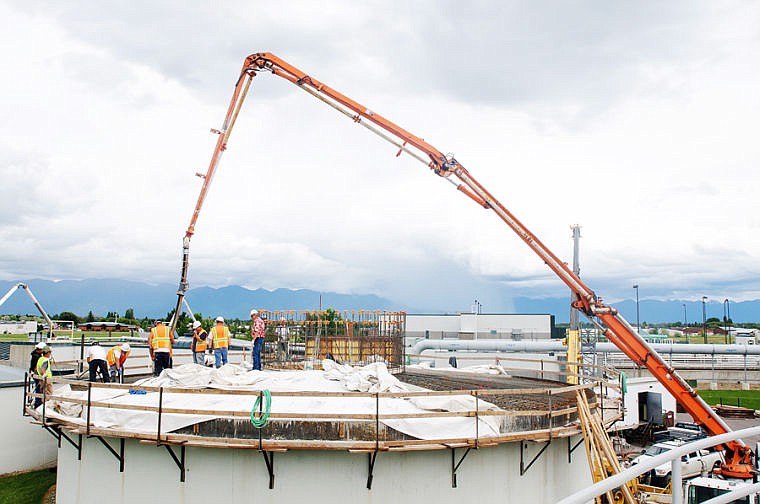 &lt;p&gt;Workers with Swank Enterprises pour a concrete lid Wednesday for the primary digester at Kalispell&#146;s wastewater treatment plant. Half of the lid was poured last week, and remaining sections were finished Wednesday. The digester handles corrosive methane gas generated as part of the treatment plant&#146;s solids reduction process and is getting an $863,000 overhaul. Financing costs and contingency reserves push the total estimated cost of the project up to about $1.2 million. Work on the primary digester should be finished by year&#146;s end.&lt;/p&gt;