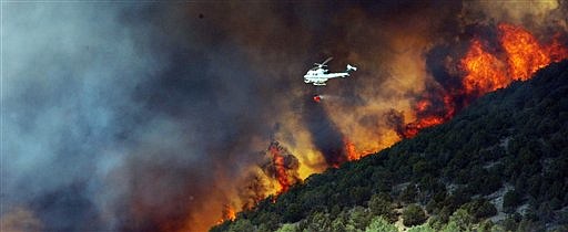 &lt;p&gt;In this Friday, June 22, 2012, file photo, emergency responders work on a wild land fire that is threatening homes in Saratoga Springs, Utah. In the tinder-dry West, where campfires, fireworks and even smoking cigarettes are banned across public lands, the Second Amendment still prevails. Despite dozens of wildfires sparked by target shooting across the West, state Legislatures are loathe to take up limits on firearms because of staunch opposition from guns rights advocates. (AP Photo/The Deseret News, Jeffrey D. Allred)&lt;/p&gt;