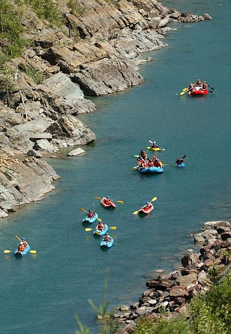 Rafters and kayakers float the Middle Fork of the Flathead River west of Essex during peak tourist season last summer. New river regulations regarding human waste and campfires are taking effect on segments of the Flathead River system. Jennifer DeMonte/Daily Inter Lake