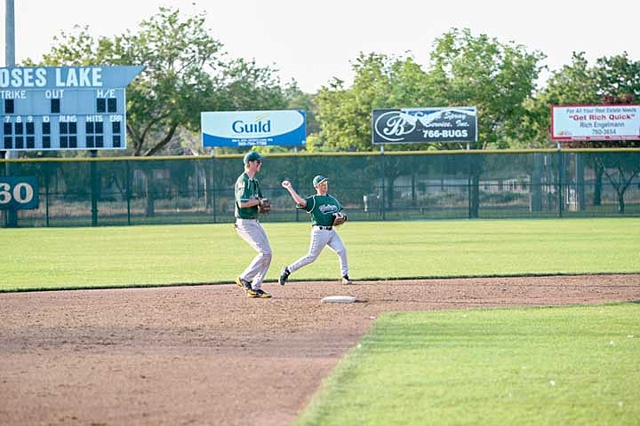 Second baseman Chase Mathews, right, throws out a runner at first. Kevin Cosper backs up the play