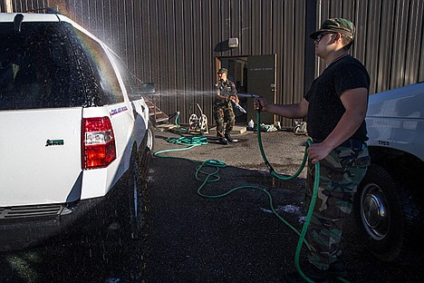 <p>Cadet Airman Jacob chicks, 16, and Sergeant Perrin Fish, 15, of the Coeur d'Alene Civil Air Patrol wash the cars in preparation for the Fourth of July Parade on Friday. The Coeur d'Alene Civil Air Patrol will be performing the opening formation and the closing formation for the Coeur d’Alene Fourth of July Parade.</p>