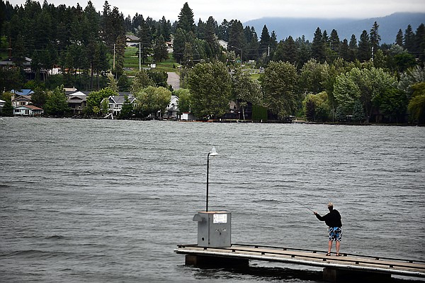 <p>Despite rough water on Flathead Lake, Bill McStay of Ferndale fishes from the dock at Wayfarers State Park on Wednesday afternoon near Bigfork.</p>