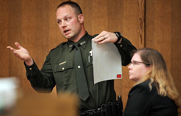 Montana State Trooper Glen Barcus of Kalispell explains the photographs he took at the scene of the fatal accident involving Evergreen teen Justine Ellen Winter and Erin Julie Thompson, 35, of Columbia Falls, and her son, Caden Vincent Odell.